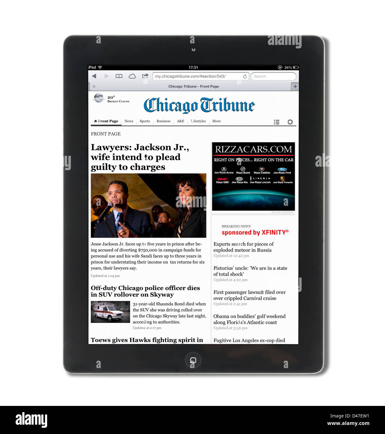 Reading the online edition of the Chicago Tribune on a 4th generation Apple iPad, USA Stock Photo