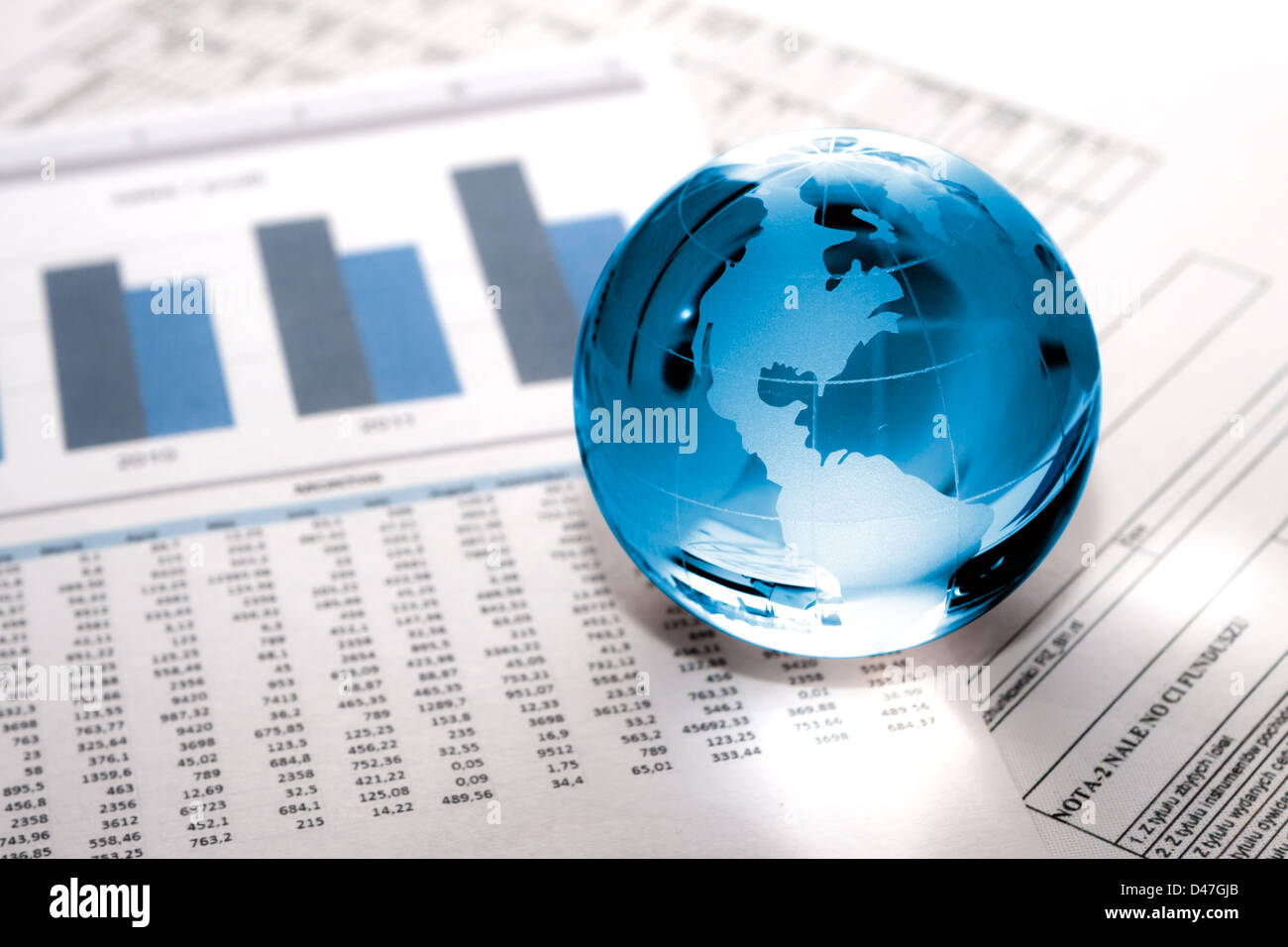 Globe showing North America and resting on financial papers Stock Photo