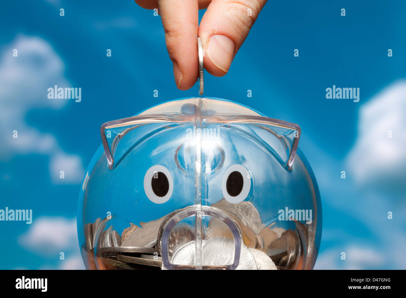 Putting a coin into a piggy bank hi-res stock photography and images ...