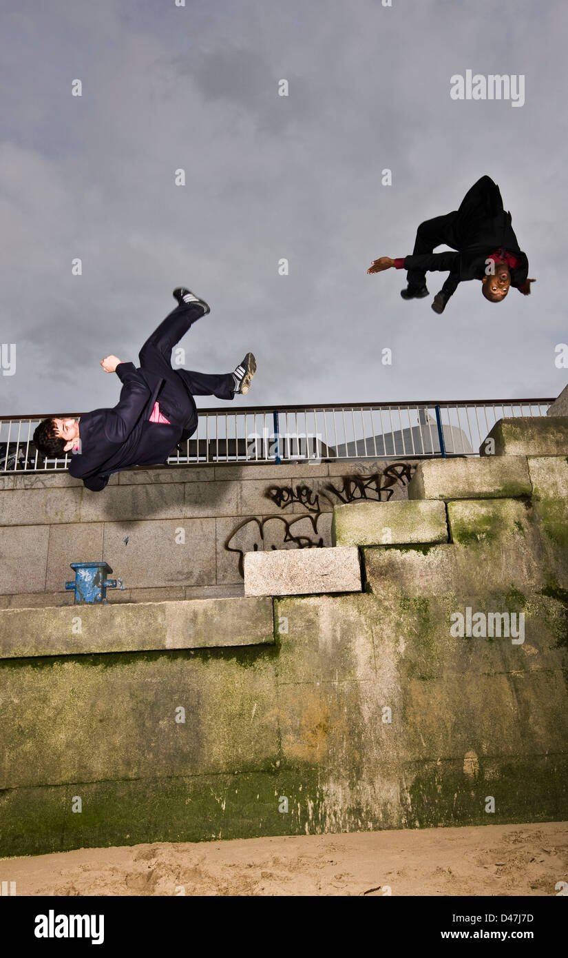 Free runners somersault concrete city steps Stock Photo