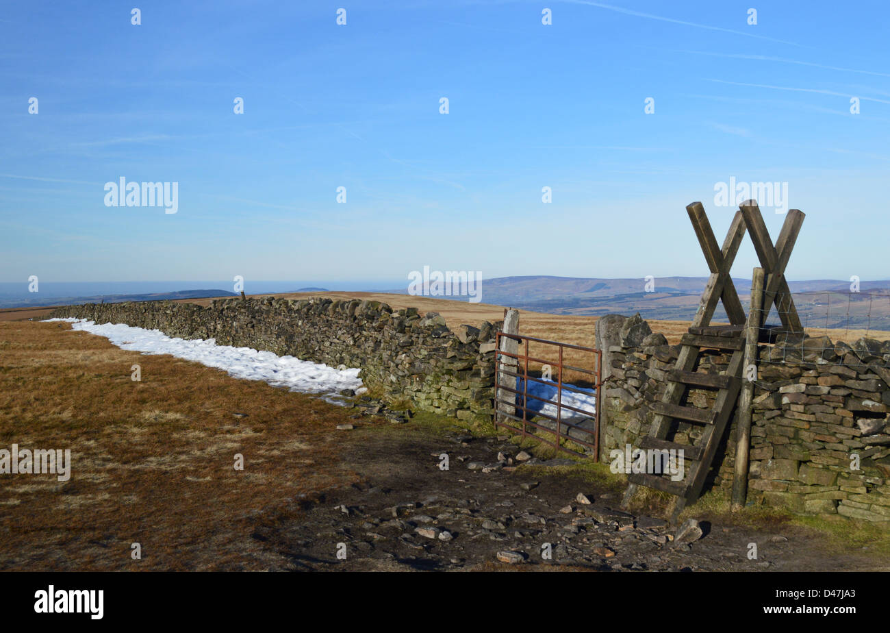 Wooden Ladder Stile & Gate in Dry Stone Wall on the Summit Pendle Hill in Winter Stock Photo