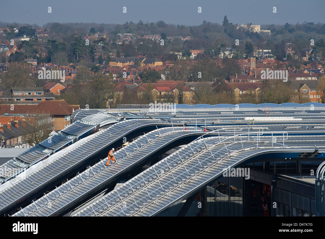 A lone Network Rail employee traverses the new roof of Reading station on 5 March 2013 Stock Photo