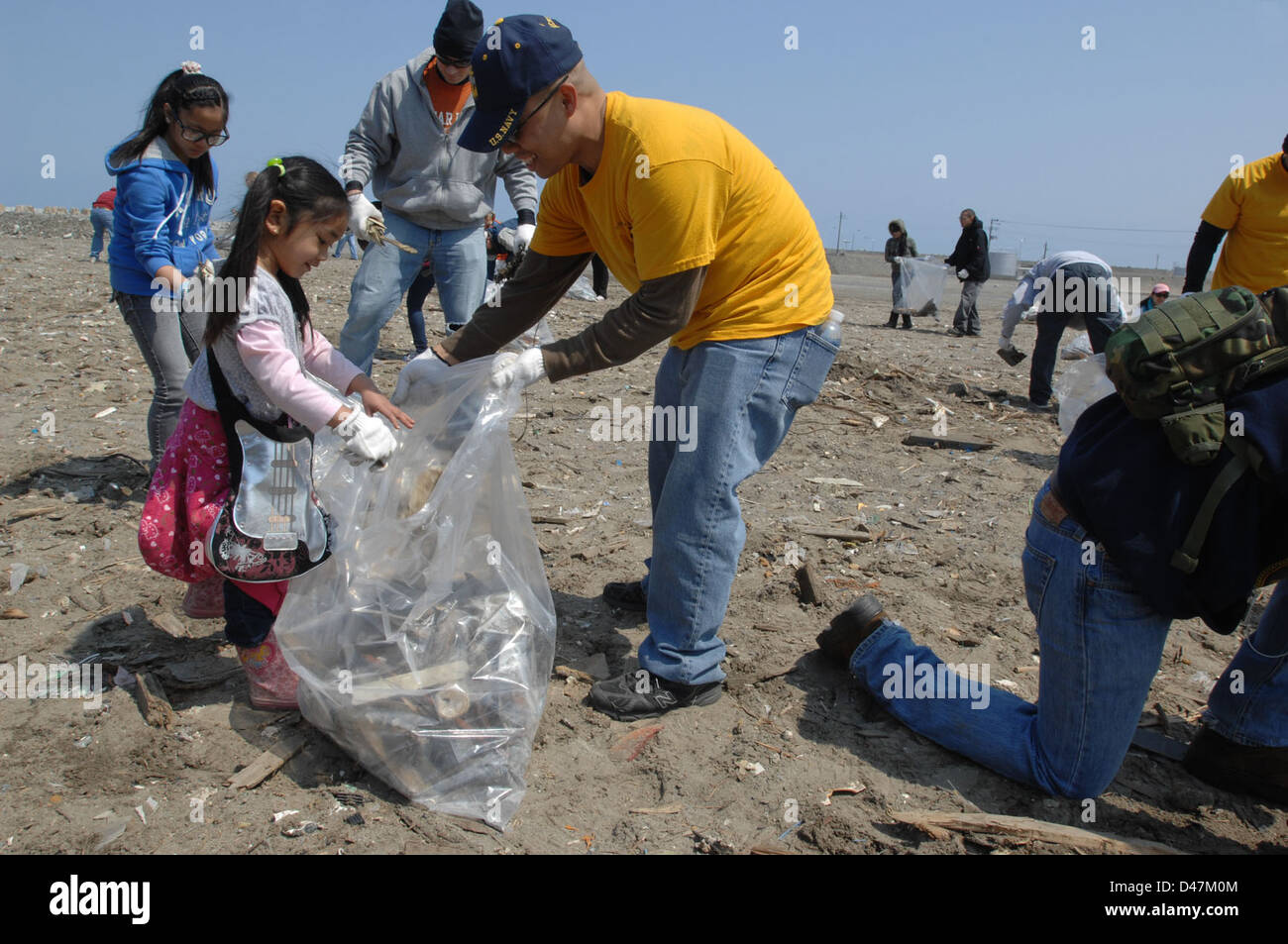 Sailors help gather trash at the Misawa Fish Port. Stock Photo