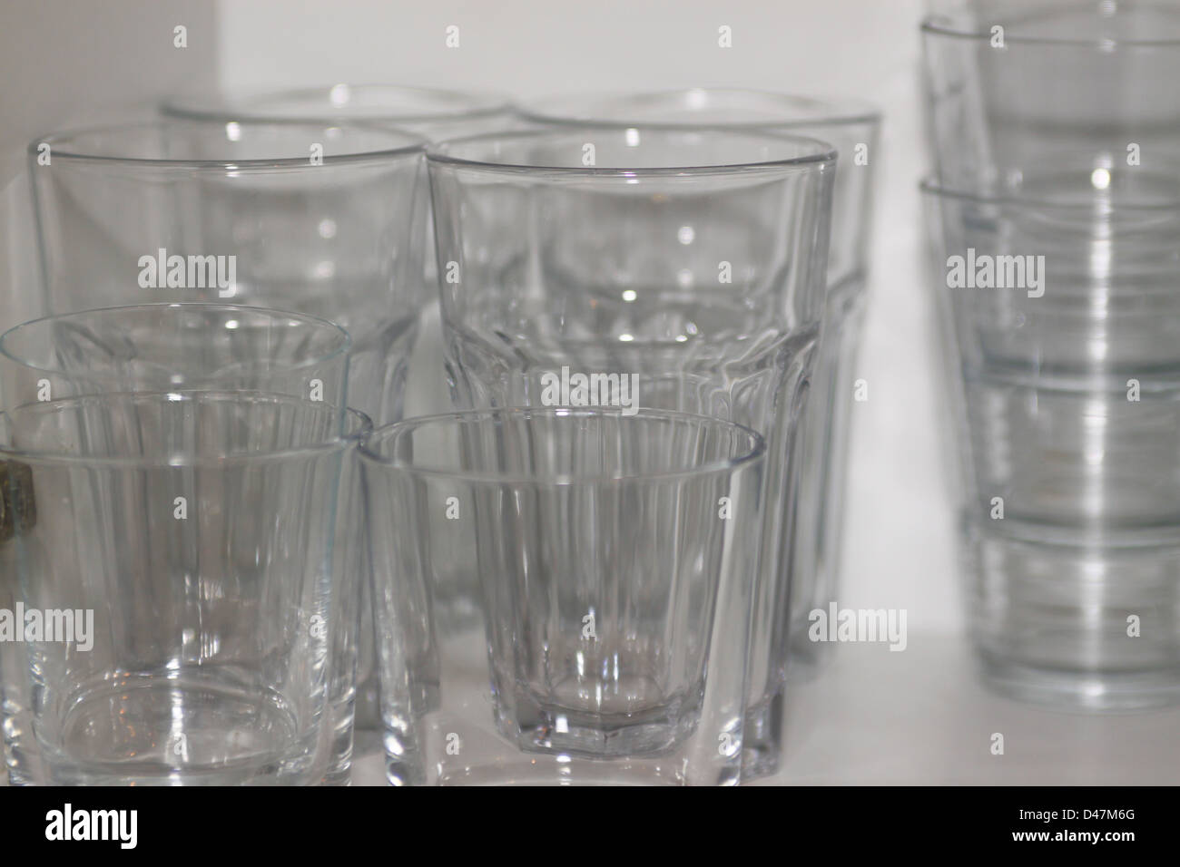 Glasses in kitchen cupboard Stock Photo Alamy