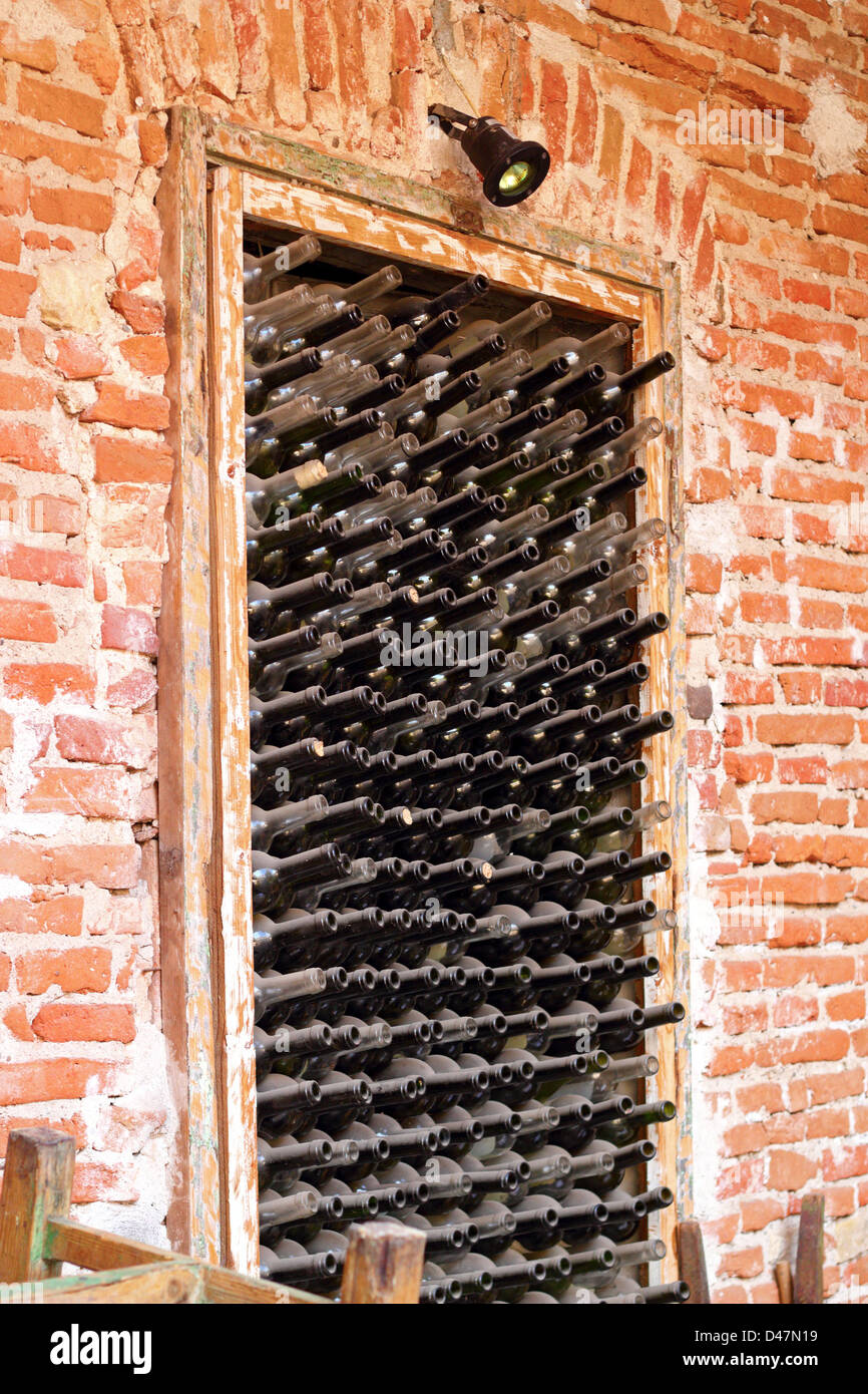 old wine bottles left in a niche on the wall Stock Photo