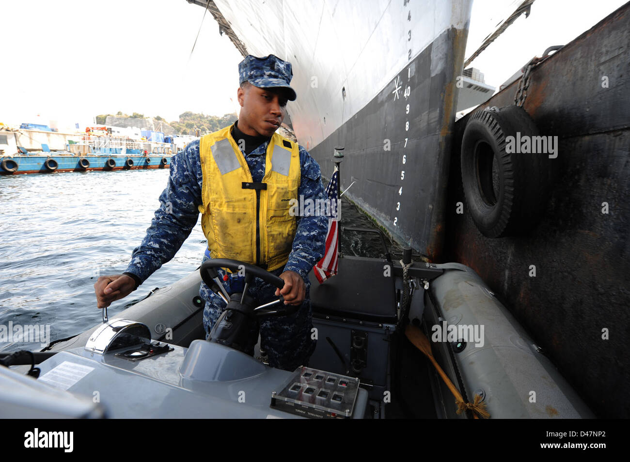 A Sailor pilots a rigid-hull inflatable boat. Stock Photo