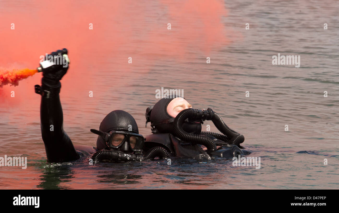 A candidate of BUDs waves a flare during a simulated dive casualty drill while training at Naval Amphibious Base Coronado. Stock Photo