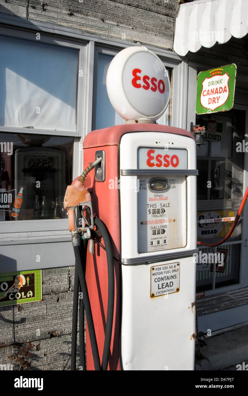 Vintage Esso gas pump in red paint trim, classic roadside Americana from the 1960's. Stock Photo