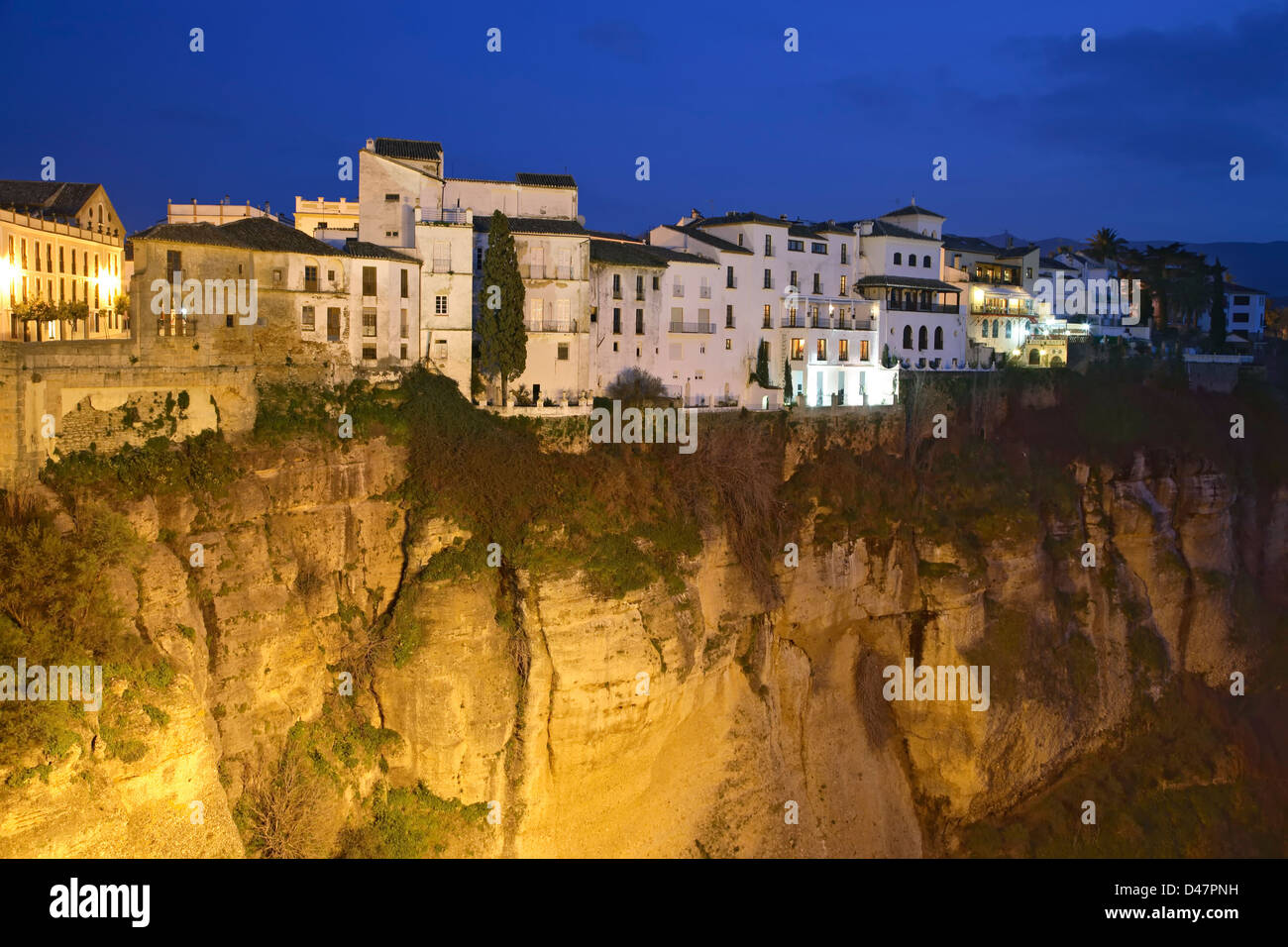 Houses atop cliff at twilight, Ronda, Spain Stock Photo