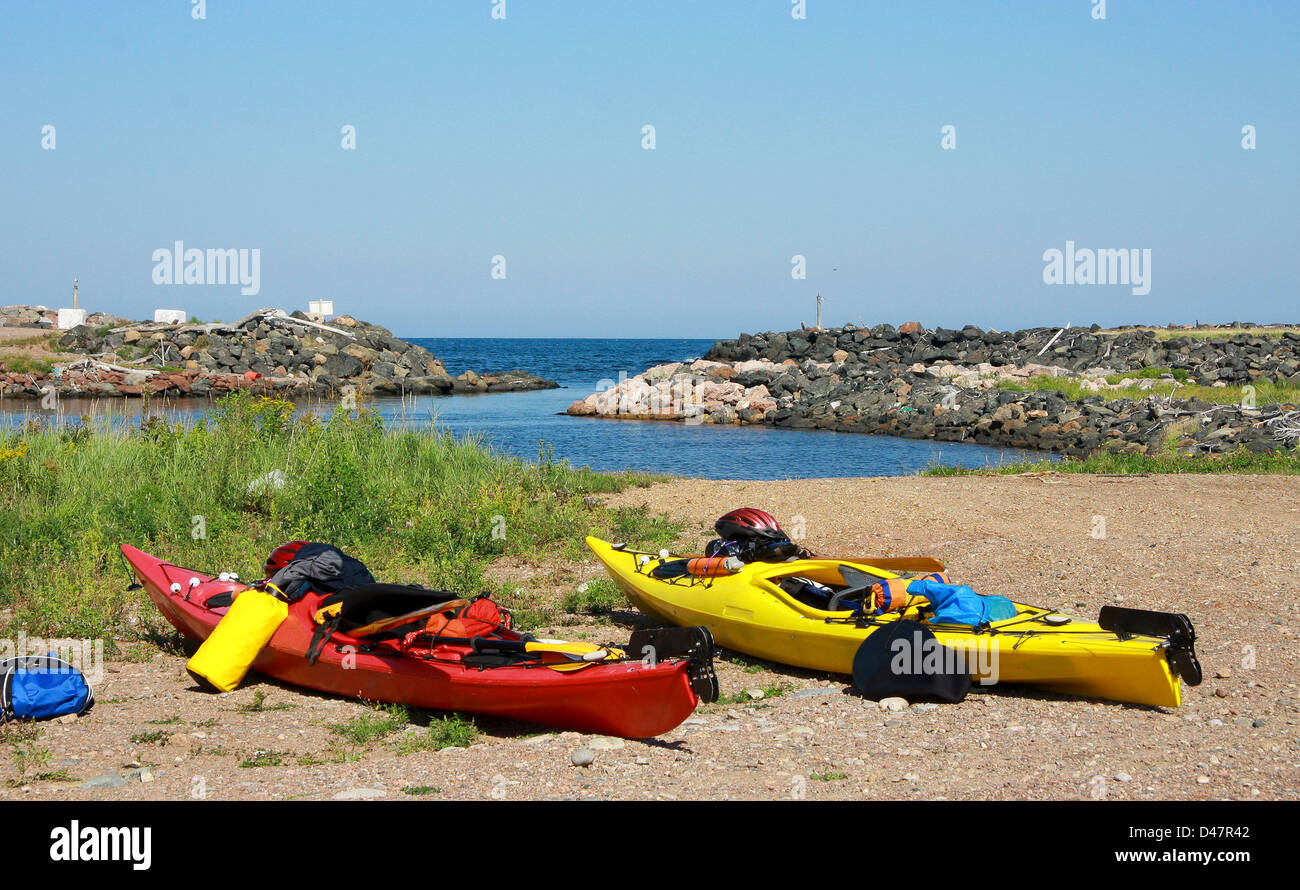 kayaks well equipped and ready for expedition, anchored on a beach of