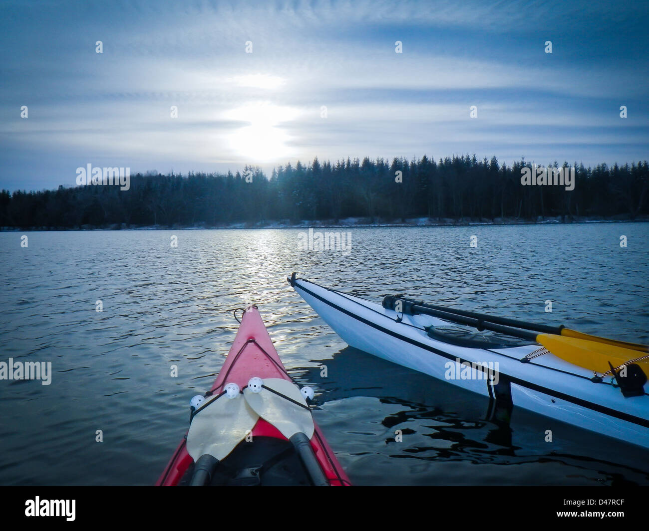 kayaks anchored at sundown on sea in Black Cove, Nova Scotia coast