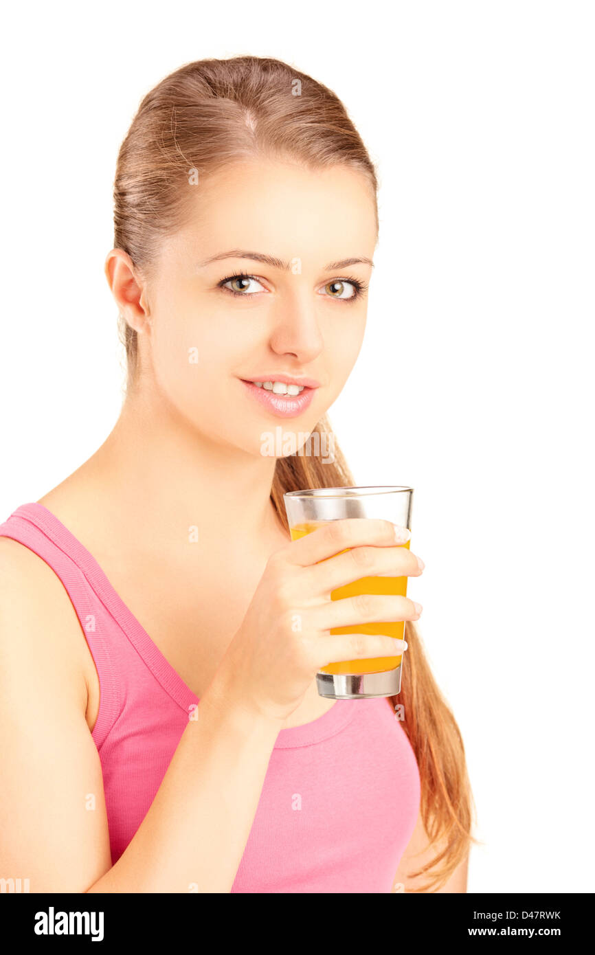Female athlete holding a glass of orange juice, refreshing after an