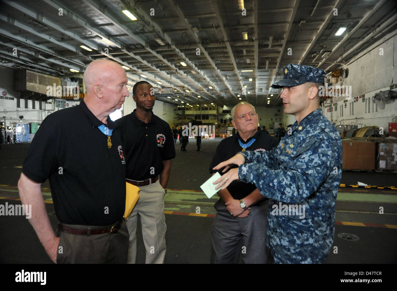 Medal of Honor recipients former U.S. Army Staff Sergeant Don Jenkins, left, and retired U.S. Army Sergeant Major Kenneth Stumpf tour the Japan-based aircraft carrier USS George Washington. Stock Photo