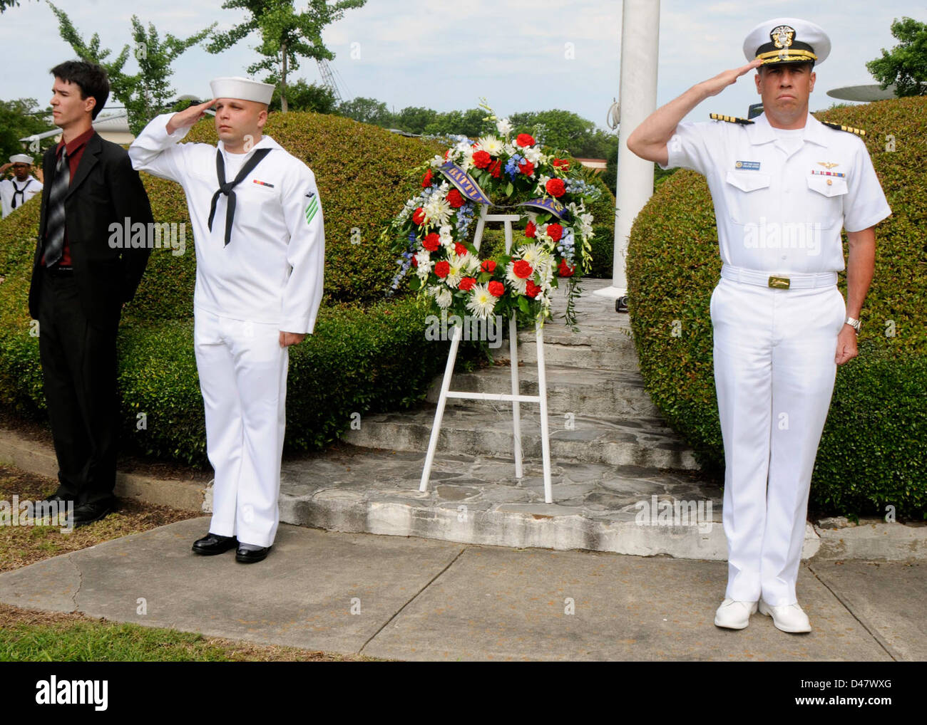 The XO of Naval Station Norfolk stands at attention and salute during