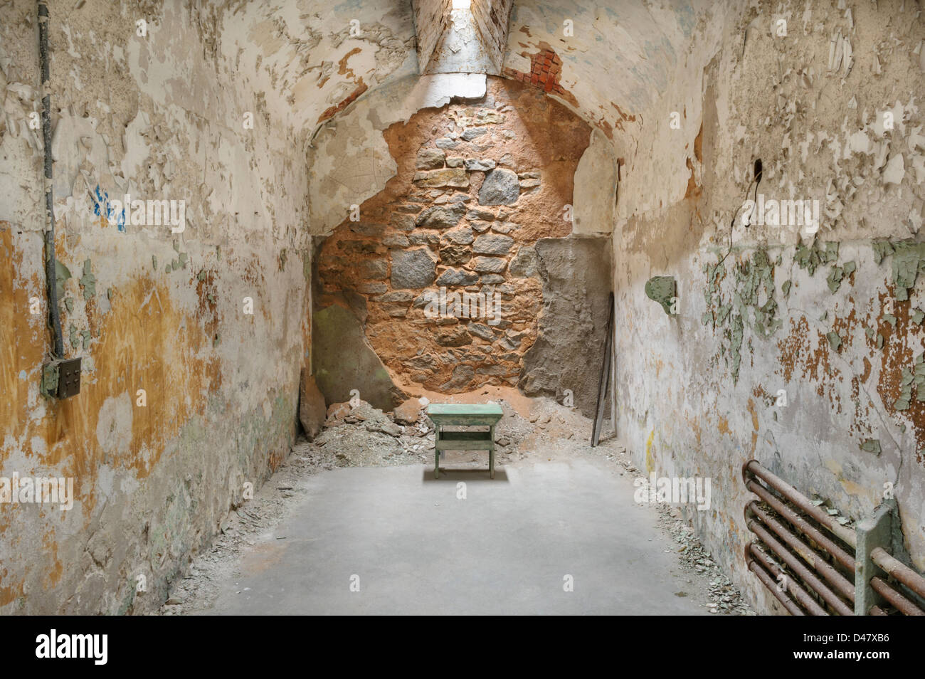 Chair in empty solitary prison cell with skylight above, Eastern State Penitentiary, Philadelphia, PA, USA. Stock Photo