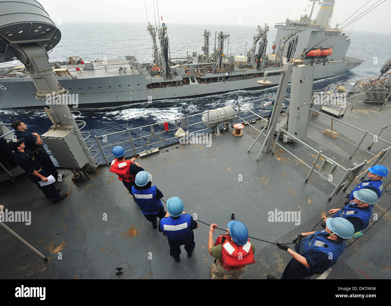 Sailors heave the phone and distance line on the bridge during a ...