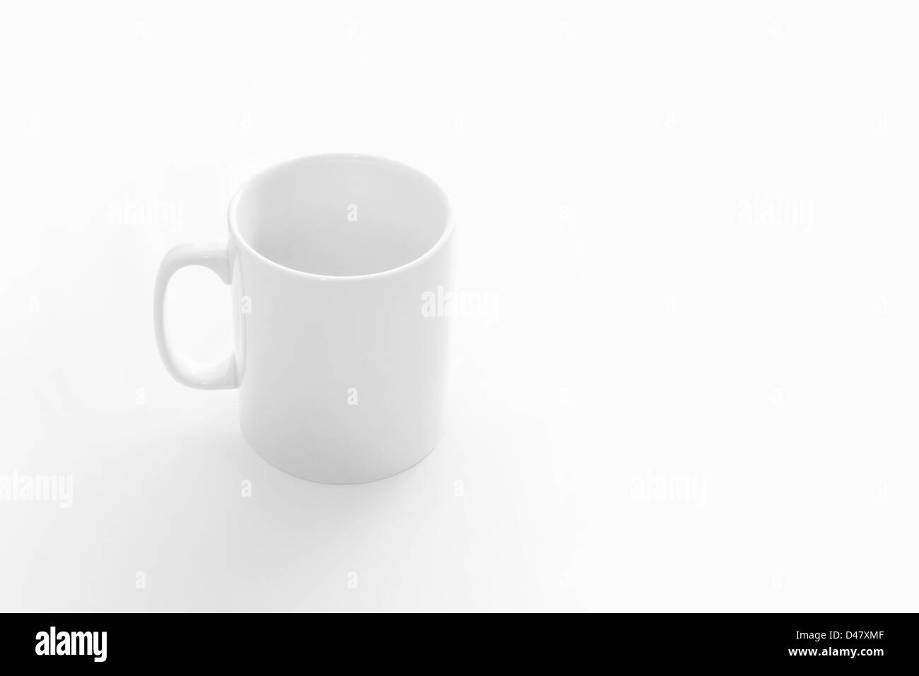 Big white empty cup on white table, front top view Stock Photo