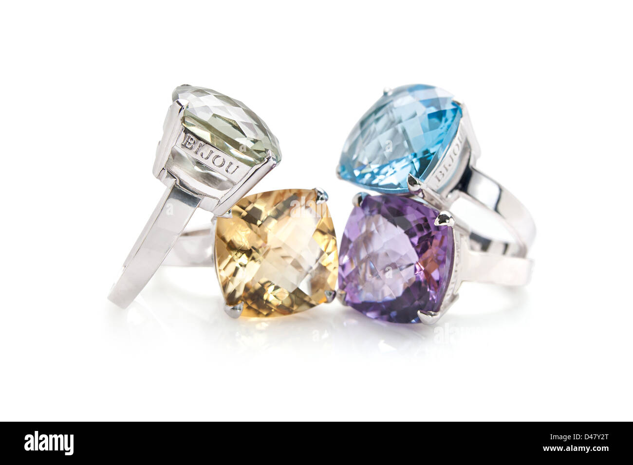 White gold rings with large amethyst, topaz, tourmaline and peridot  precious stones inset, yellow, blue purple, yellow, green. Stock Photo