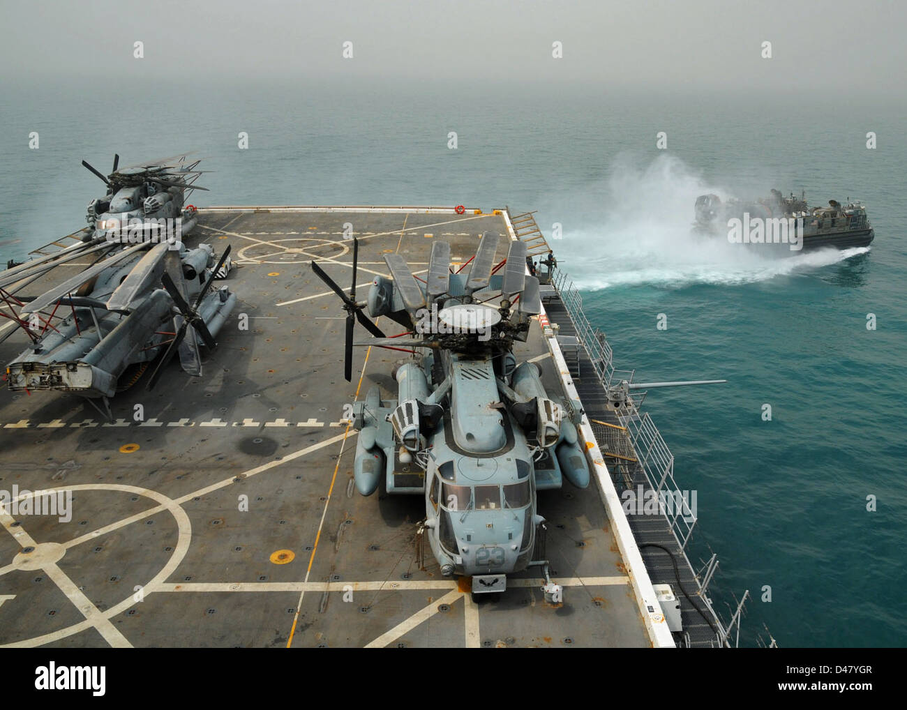 A Landing Craft Air Cushion (LCAC) departs the well deck of a ship in ...