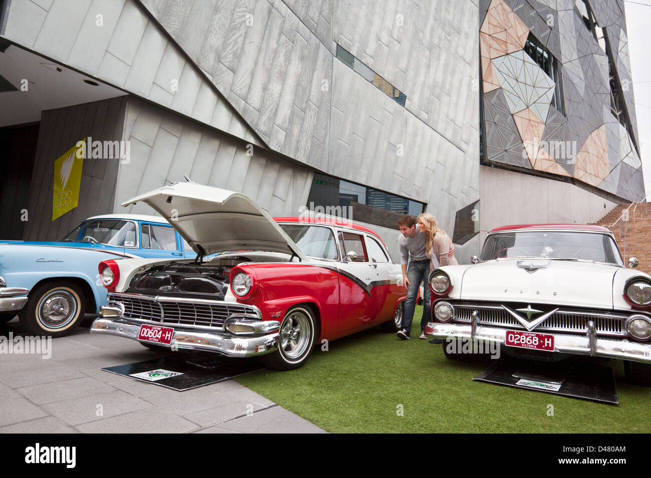 Couple looking at classic cars exhibition at Federation Square