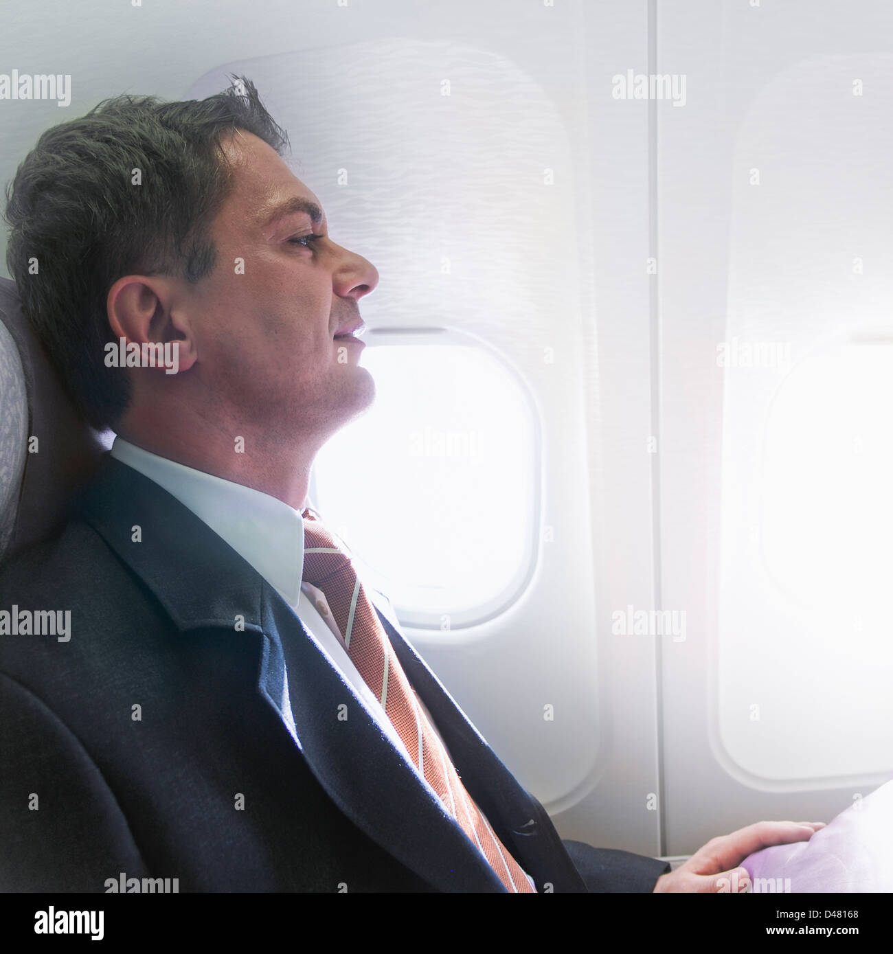Man in a suit on a plane hires stock photography and images Alamy