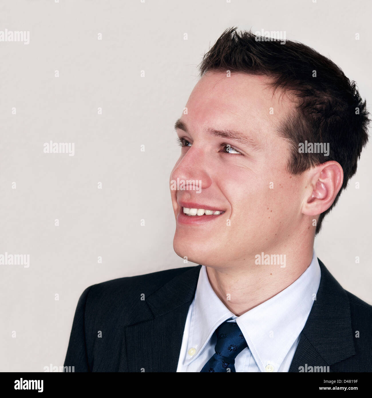 Portrait of smiling young businessman in suit Stock Photo