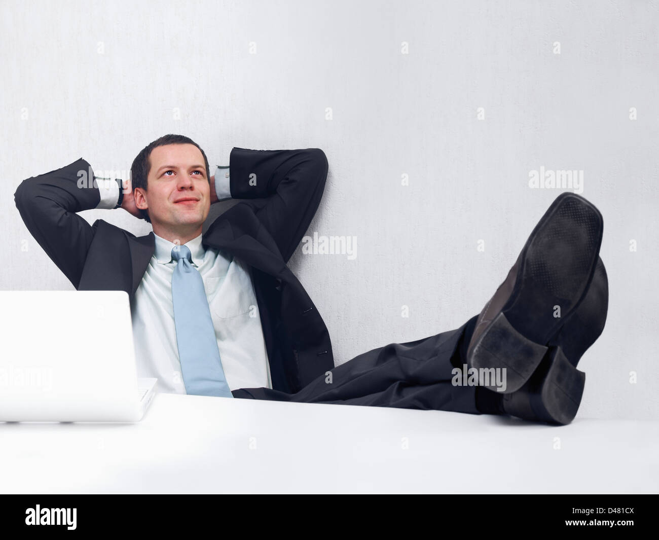 A businessman daydreaming of good things to come. Stock Photo
