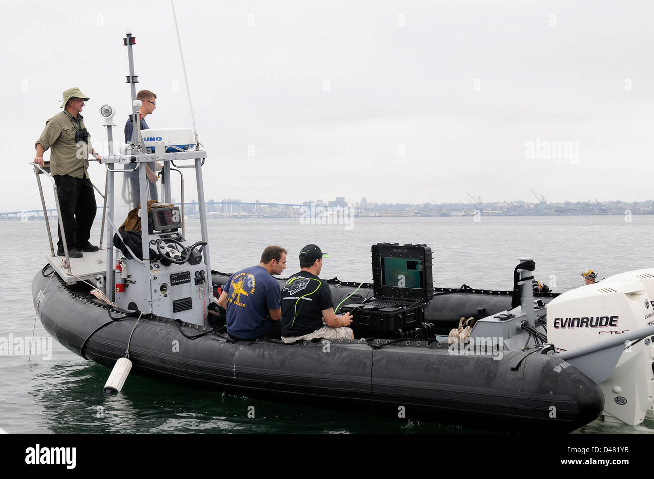 Sailors observe a monitor displaying. Stock Photo