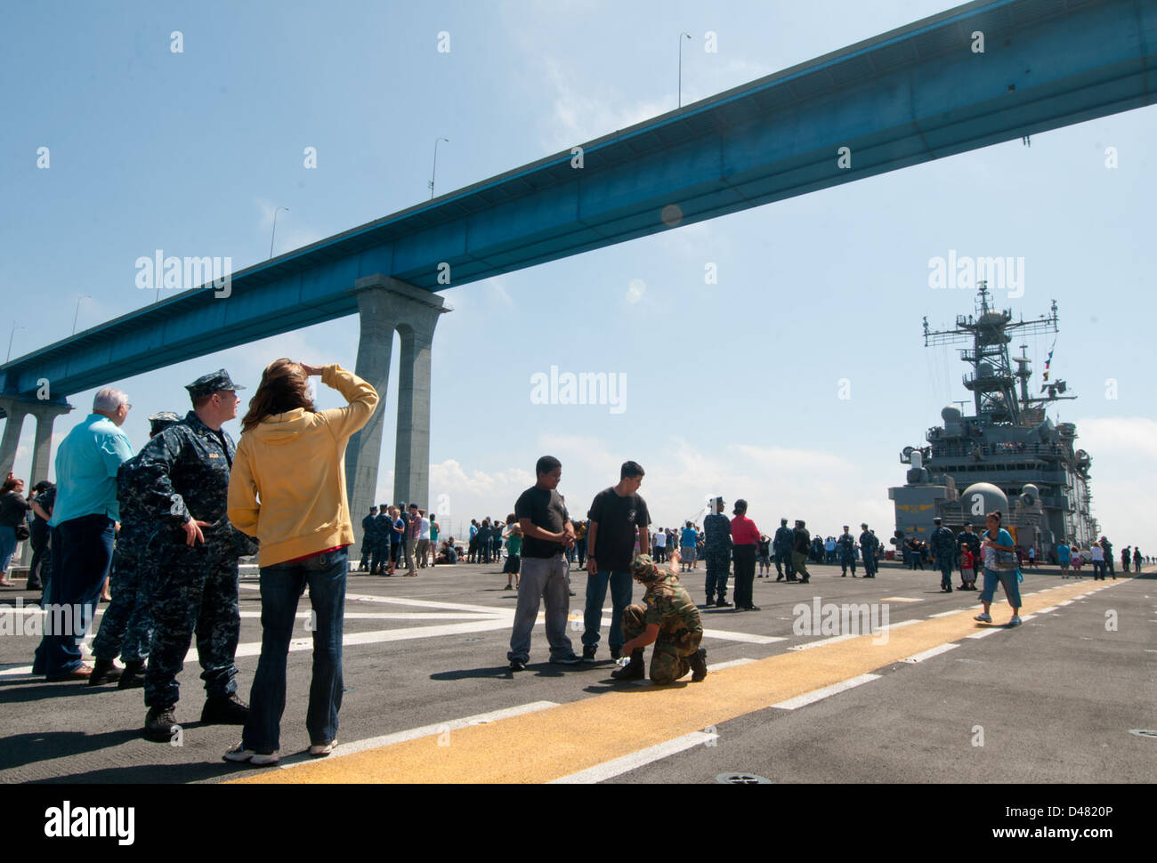 Friends and family watch USS Peleliu transits beneath the Coronado Bay Bridge. Stock Photo