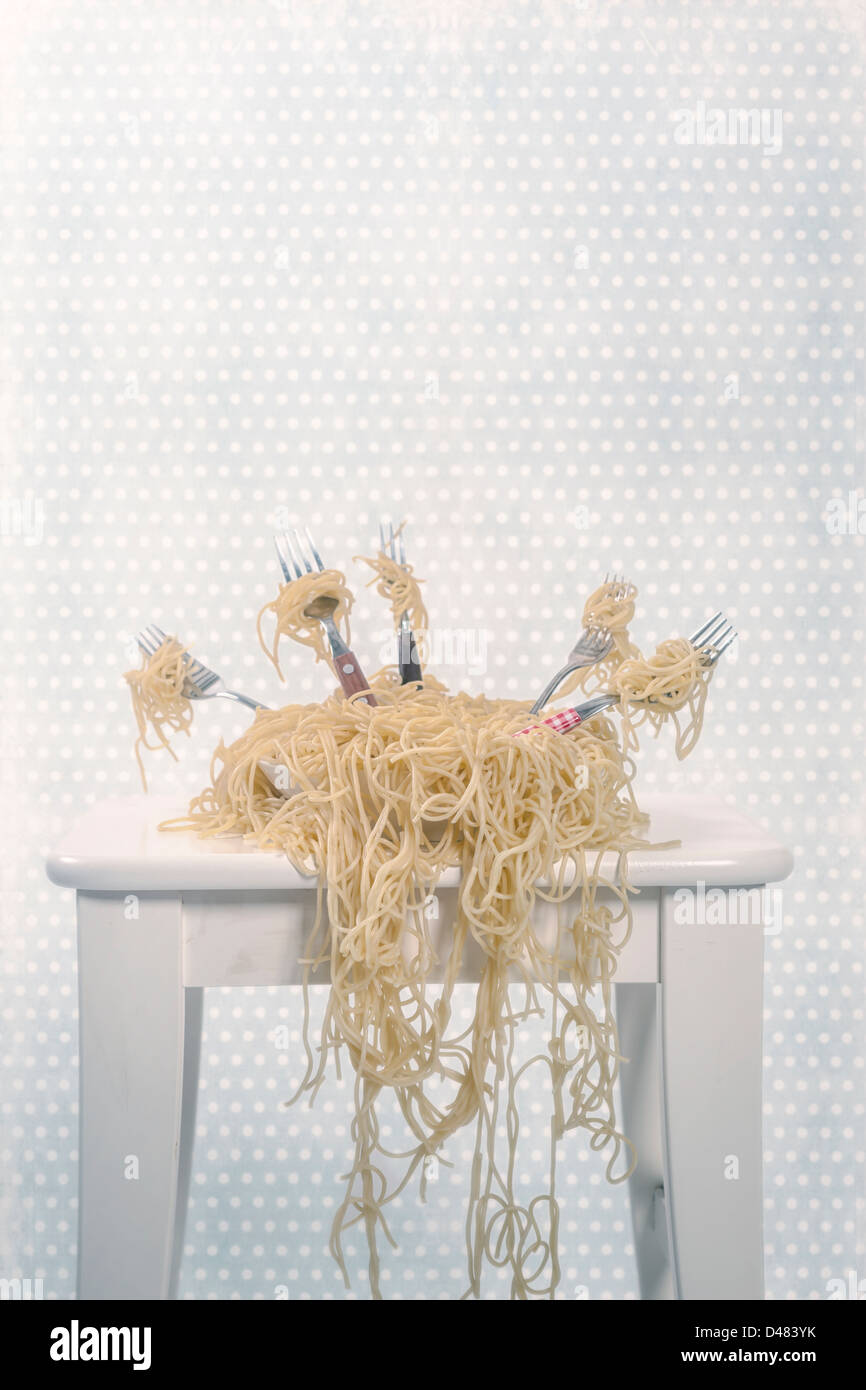 a plate full of spaghetti with five forks Stock Photo