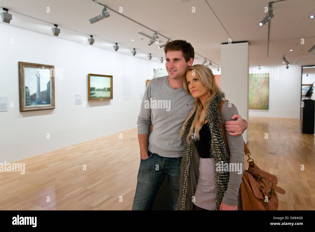 Couple looking at paintings in gallery. National Gallery of Victoria, Melbourne, Victoria, Australia Stock Photo