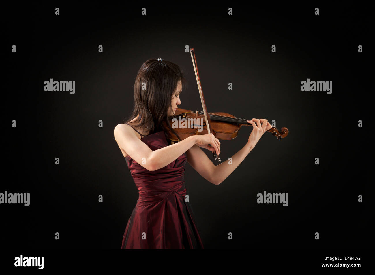 young asian woman playing the violin on black background Stock Photo ...
