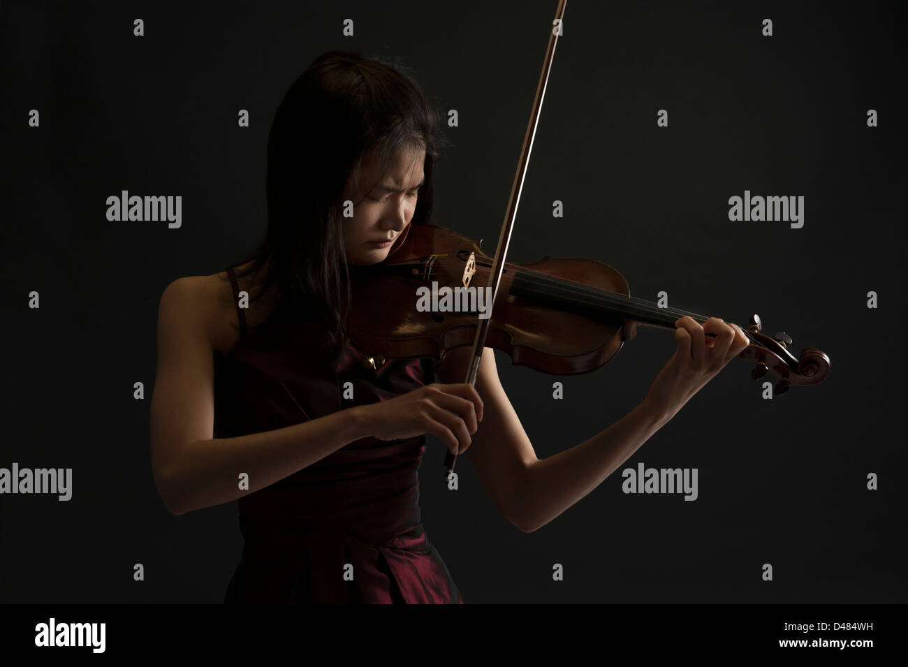 young asian woman playing the violin on black background Stock Photo ...