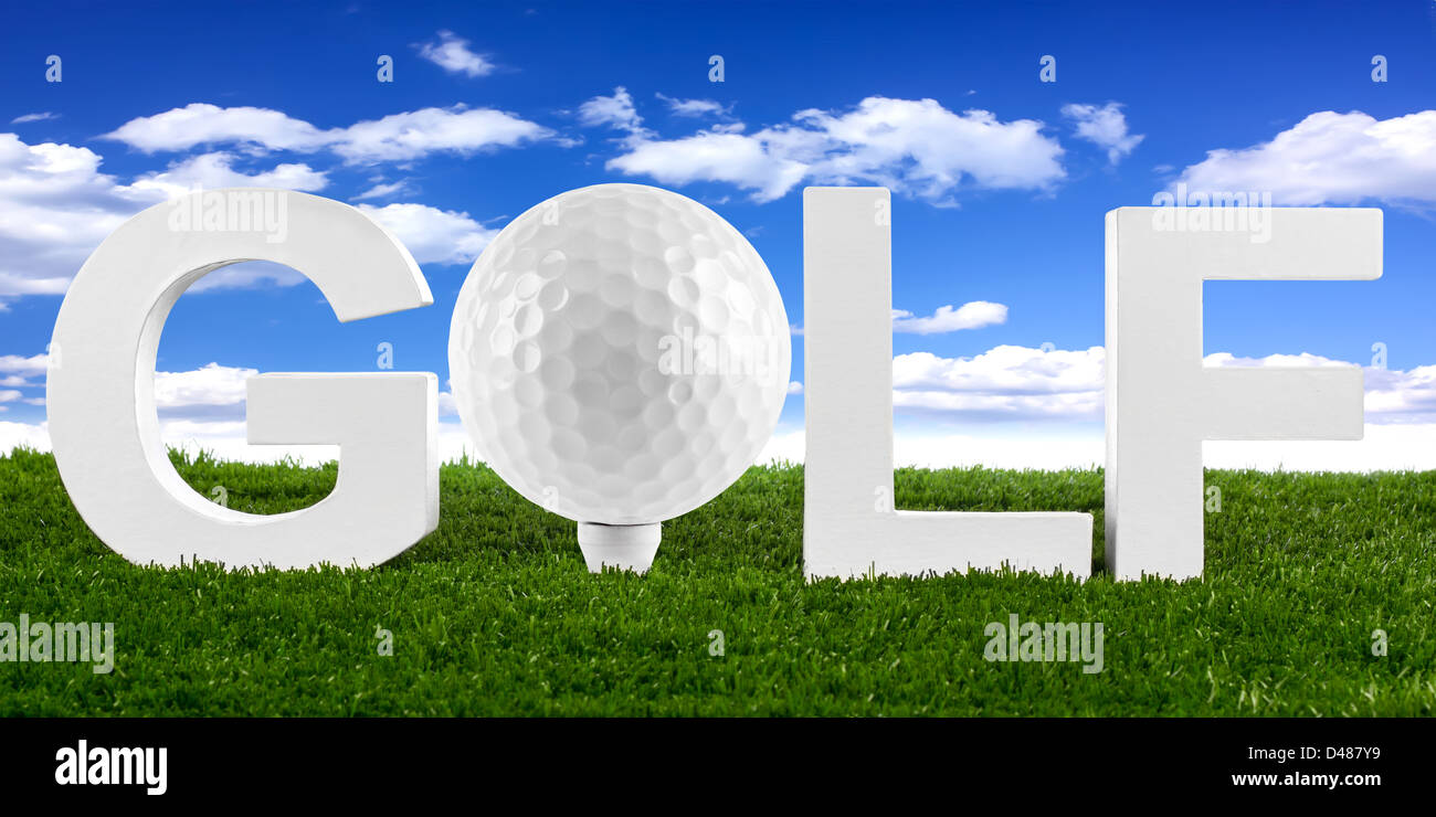 golf lettering with ball on tee on gras Stock Photo