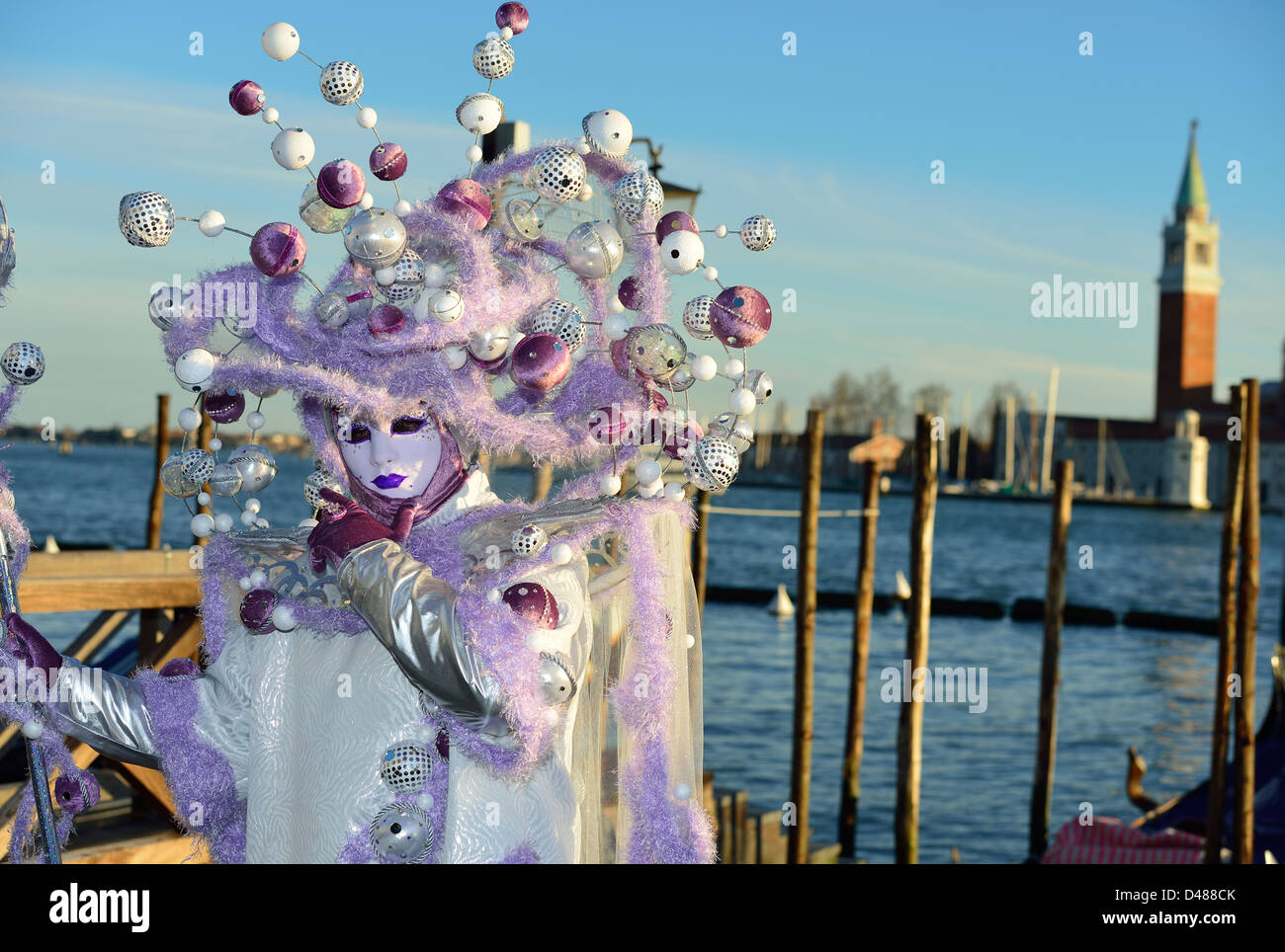 Masks pose in front of the island and church of San Giorgio Maggiore during 2013 carnival; Venice; Veneto, Italy. Stock Photo