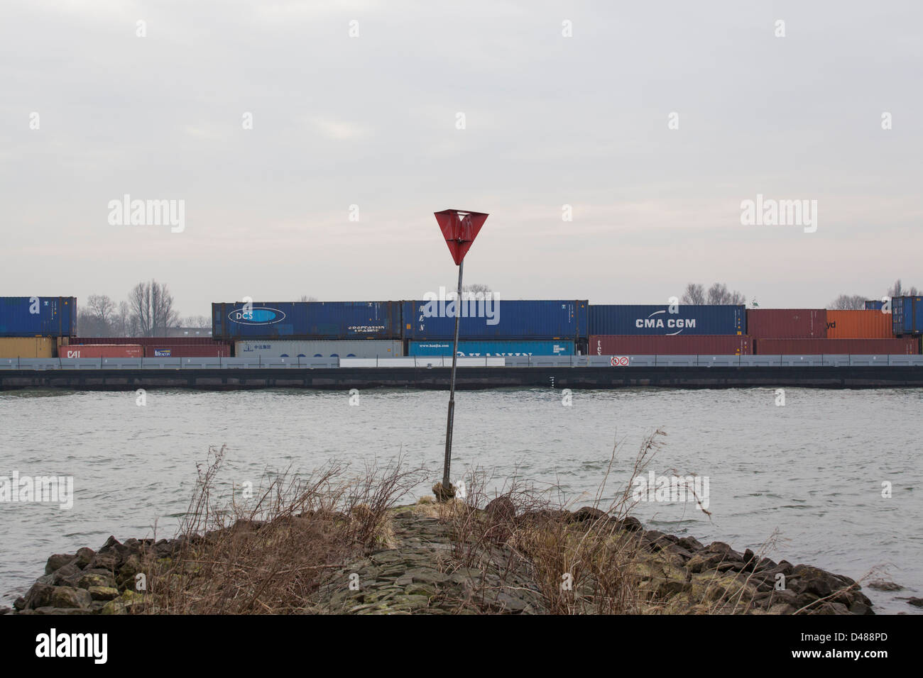 Container ship with Chinese freight on the river Merwede in the Netherlands Stock Photo
