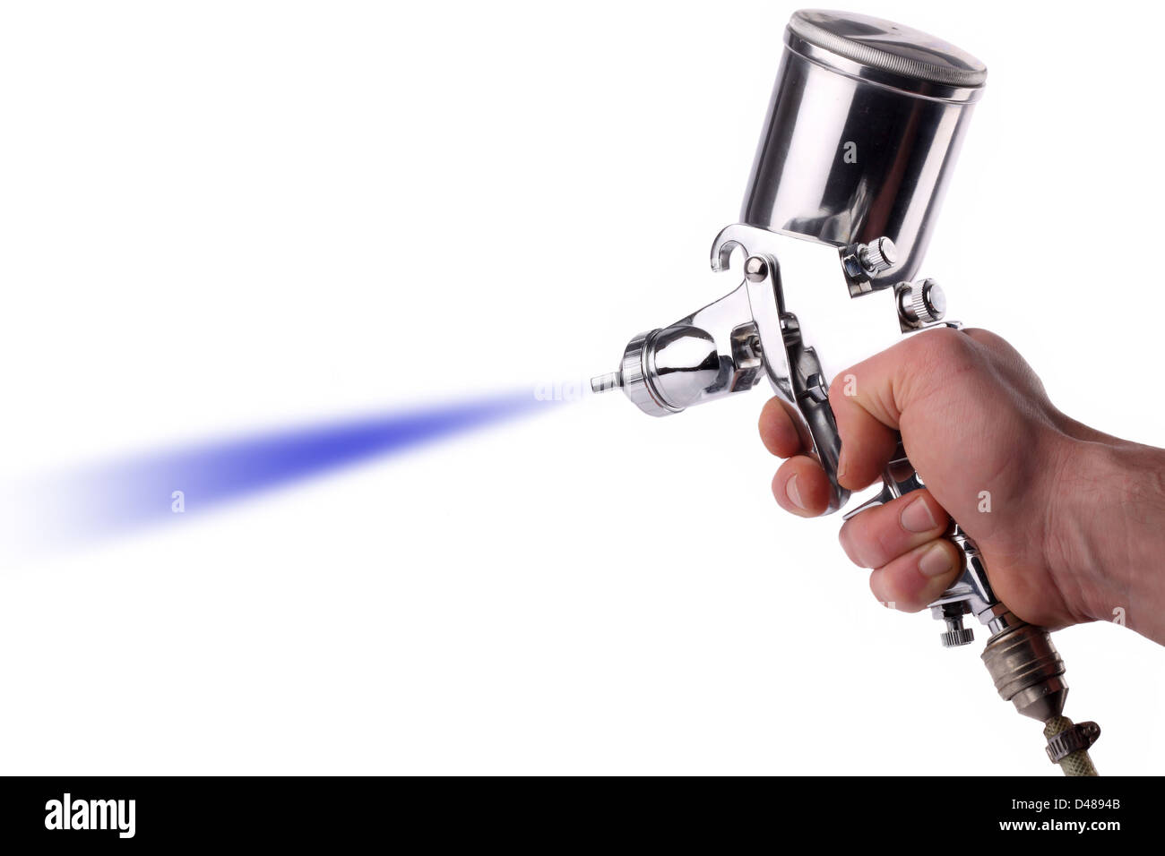 A hand with a spray gun at work. Stock Photo