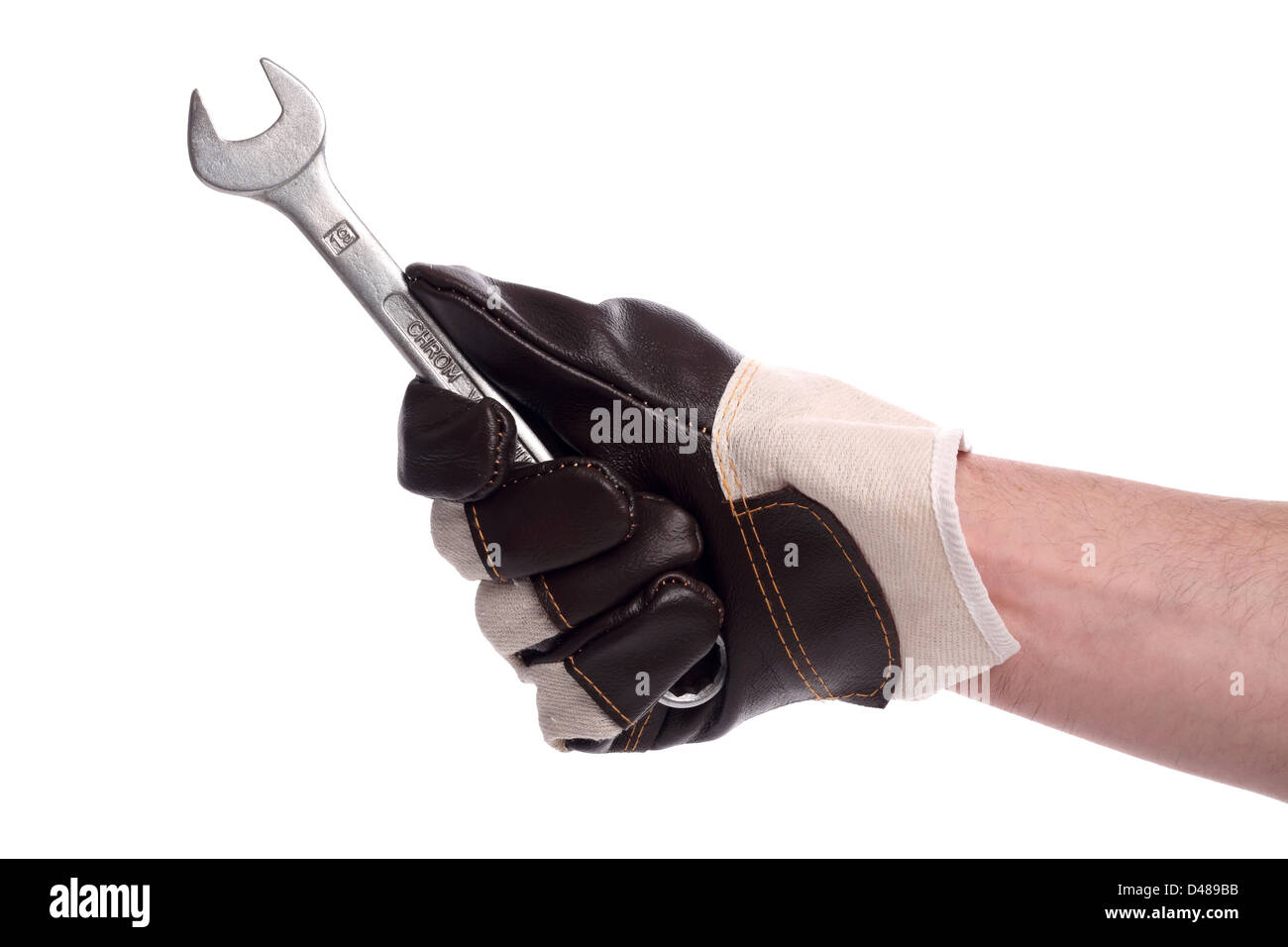 a wrench in a hand with working glove. Stock Photo
