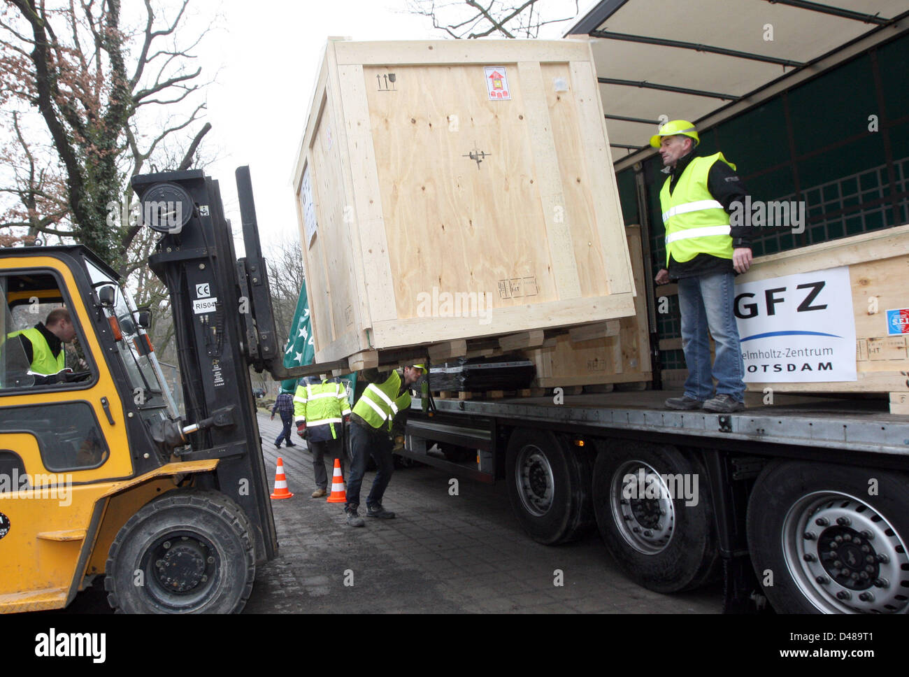 Workers deliver a new precision measuring instrument for Germany's