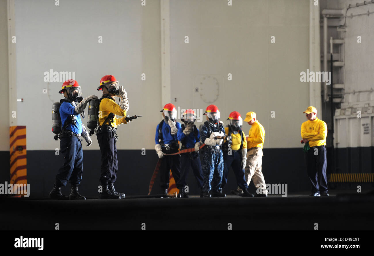 Sailors aboard the USS George H.W. Bush practice firefighting ...