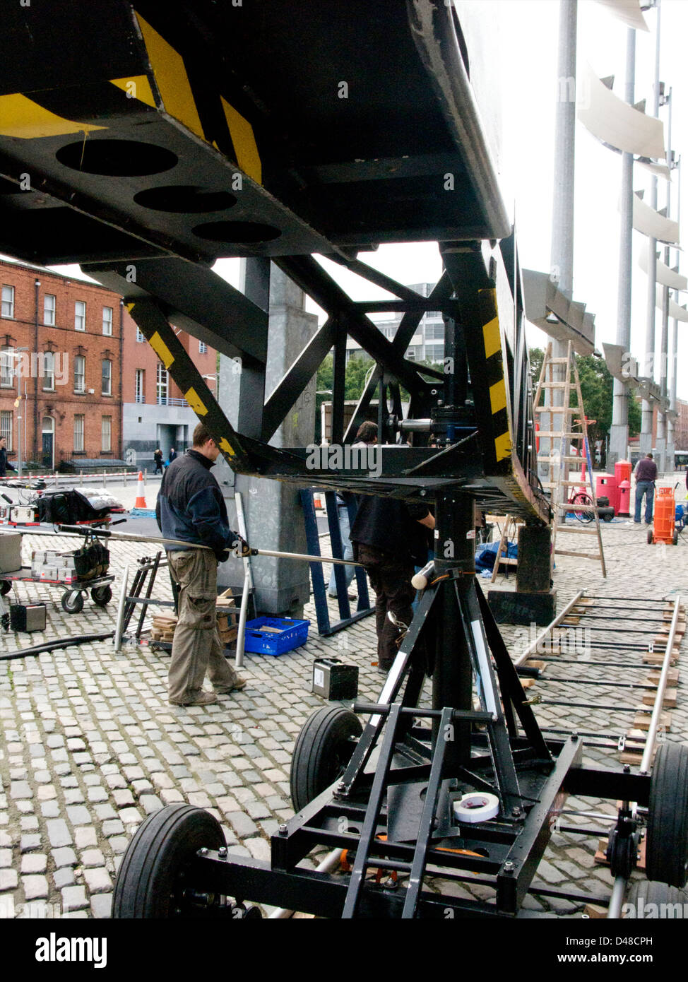 A film set with film equipment and rigs/rigging and transport trucks in Smithfield Square Dublin, Ireland Stock Photo