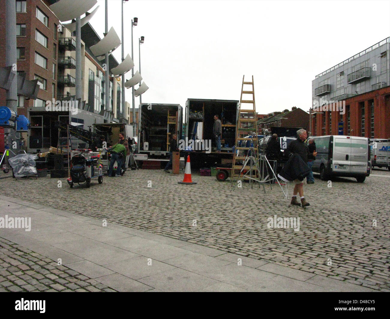 A film set with film equipment and rigs/rigging and transport trucks in Smithfield Square Dublin, Ireland Stock Photo