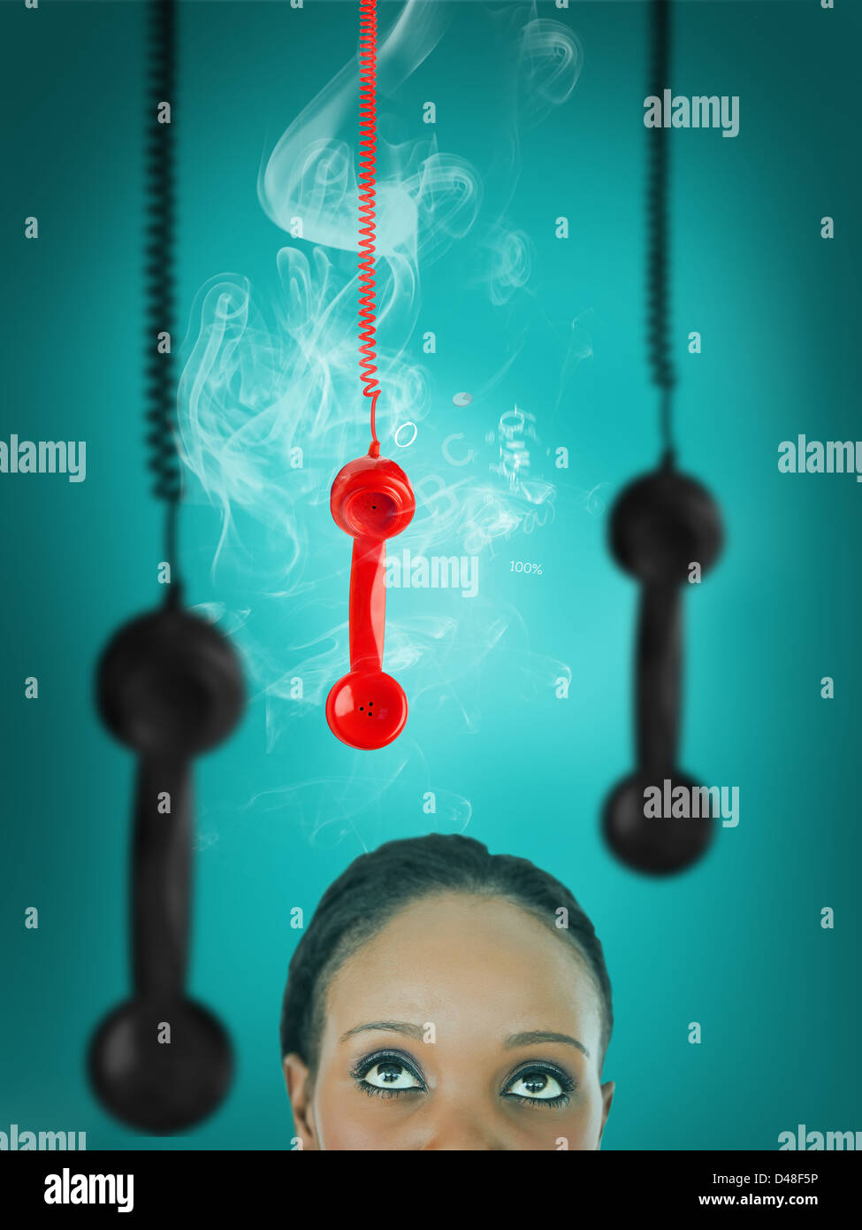 Woman looking up at hanging telephone receiver Stock Photo