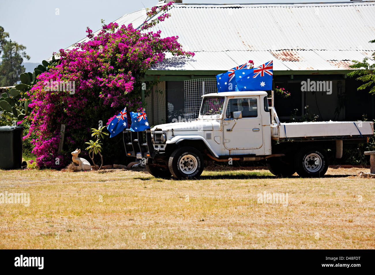 Australian Flags on a old motor vehicle in front of a country house Stock Photo