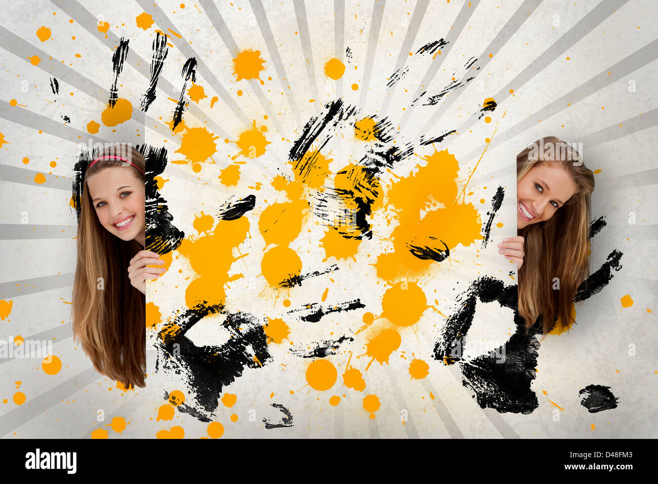 Two pretty girls holding abstract art Stock Photo