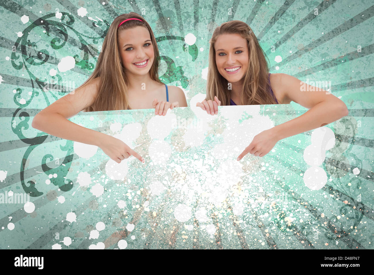 Pretty girls pointing to advertisement card Stock Photo