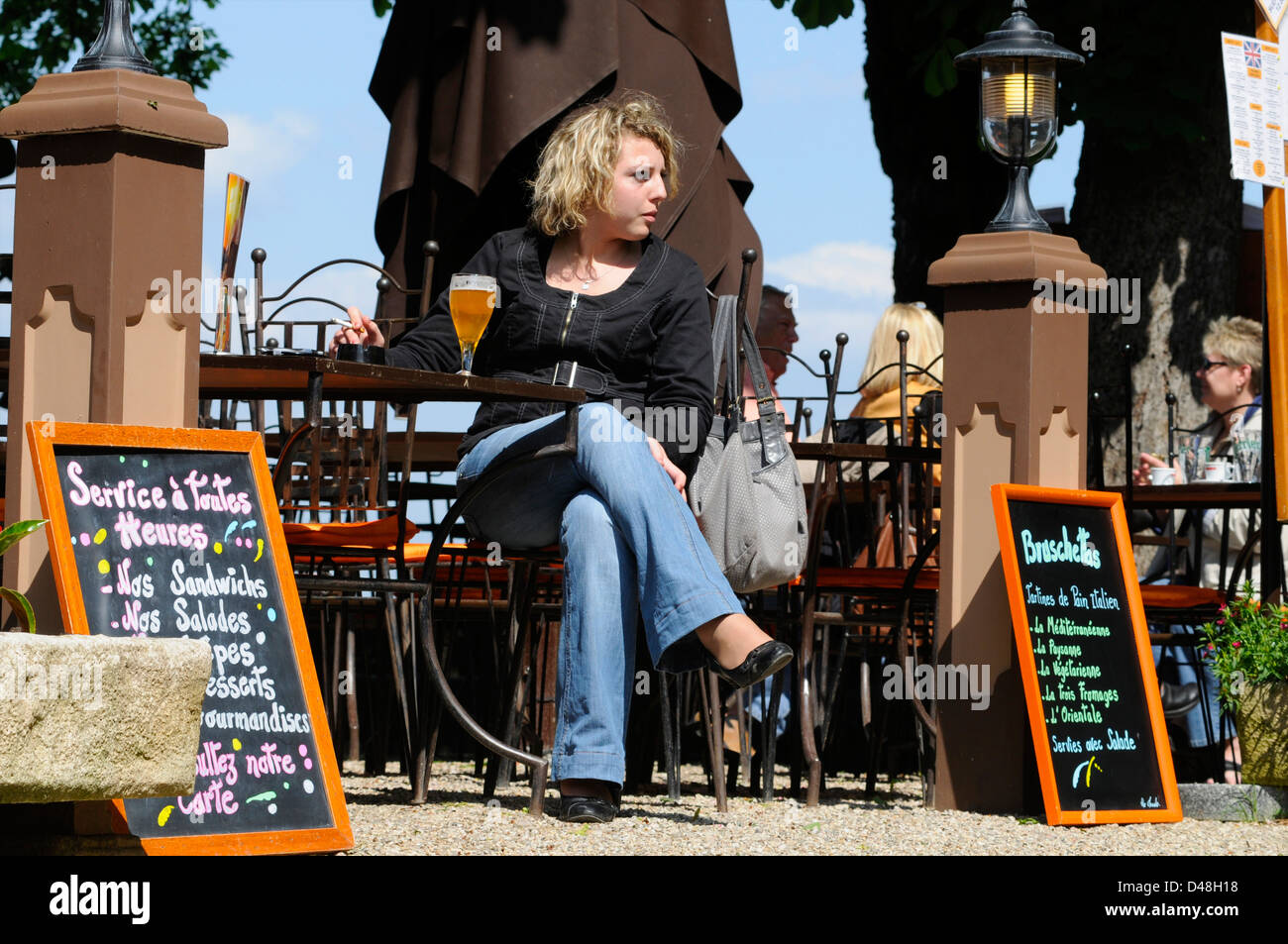 New laws mean that smokers are now forced to smoke outside cafés and restaurants in France. Codes, Tarn, France Stock Photo