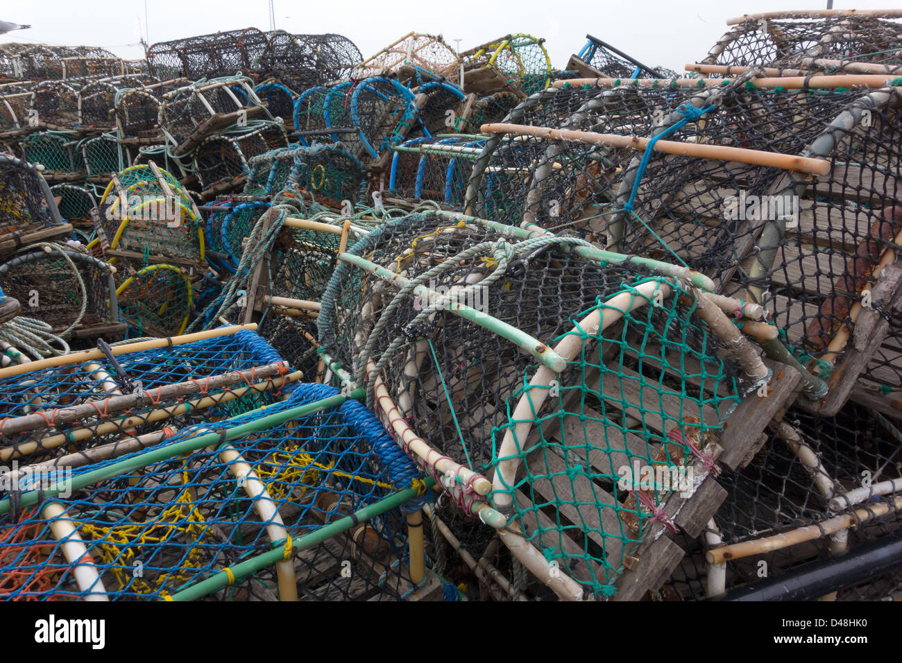 Lobster or crab pots stacked on the quayside on the east side of Whitby Harbour North Yorkshire UK Stock Photo