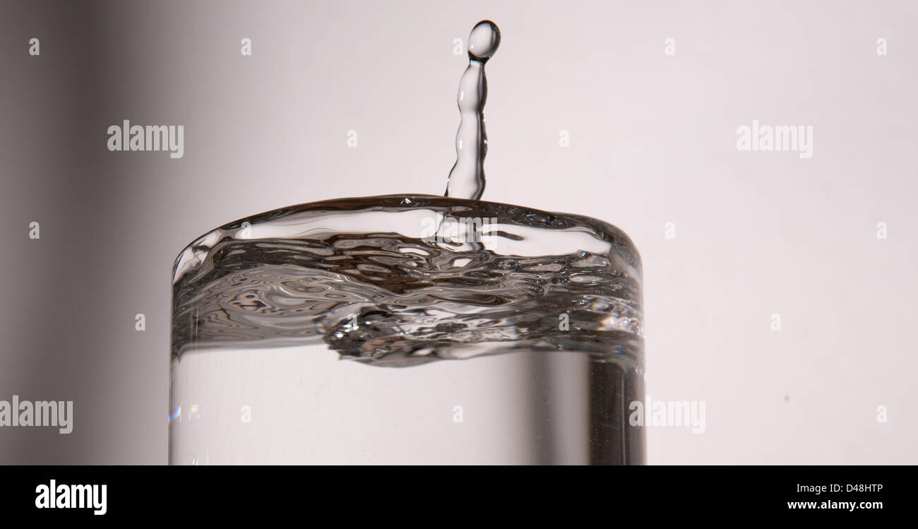 ILLUSTRATION - An illustrated picture shows a drop of water falling into a nearly full glass of water in Hanover, Germany, 08 March 2013. Photo: Lukas Schulze Stock Photo