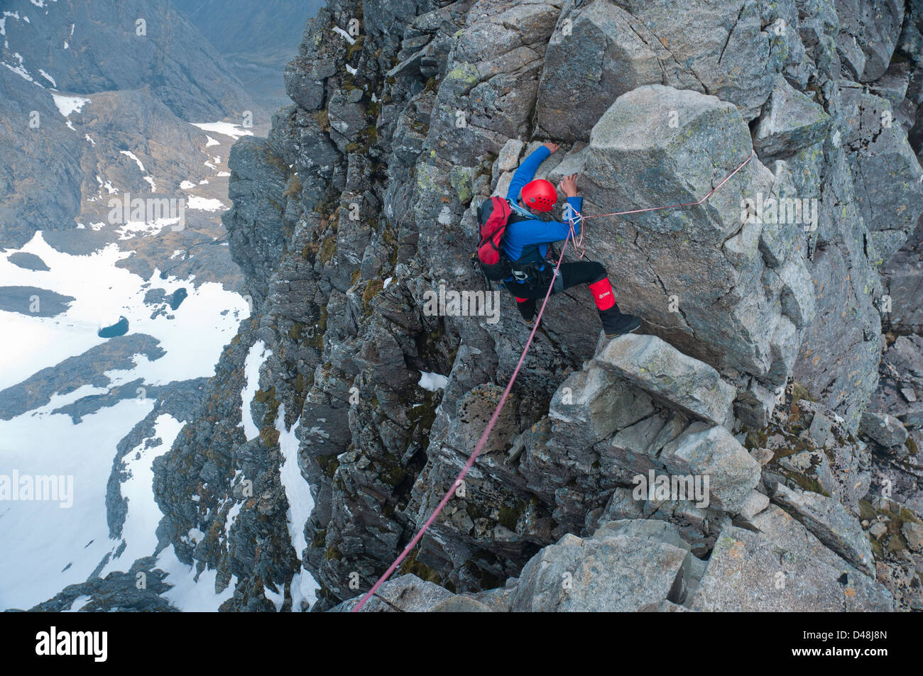 Climber descends into a gap on Tower Ridge, a classic climb on Ben